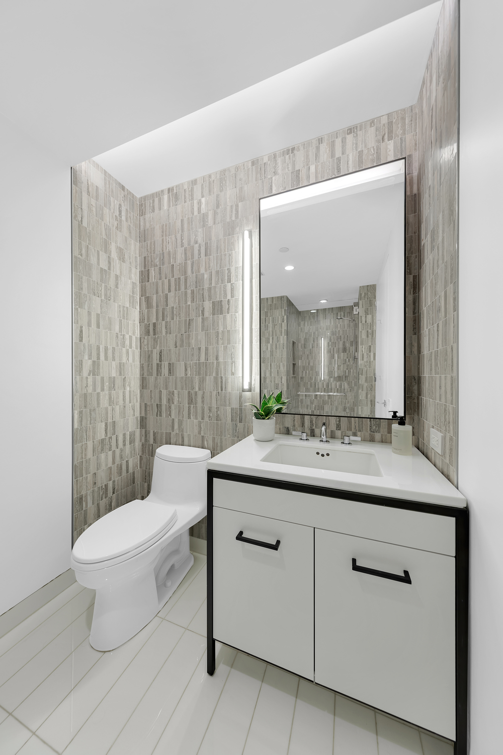 70 Charlton Street, Unit 3F Manhattan, NY 10014 - Photo 10 of 15 a bathroom with a granite countertop sink a toilet and a mirror