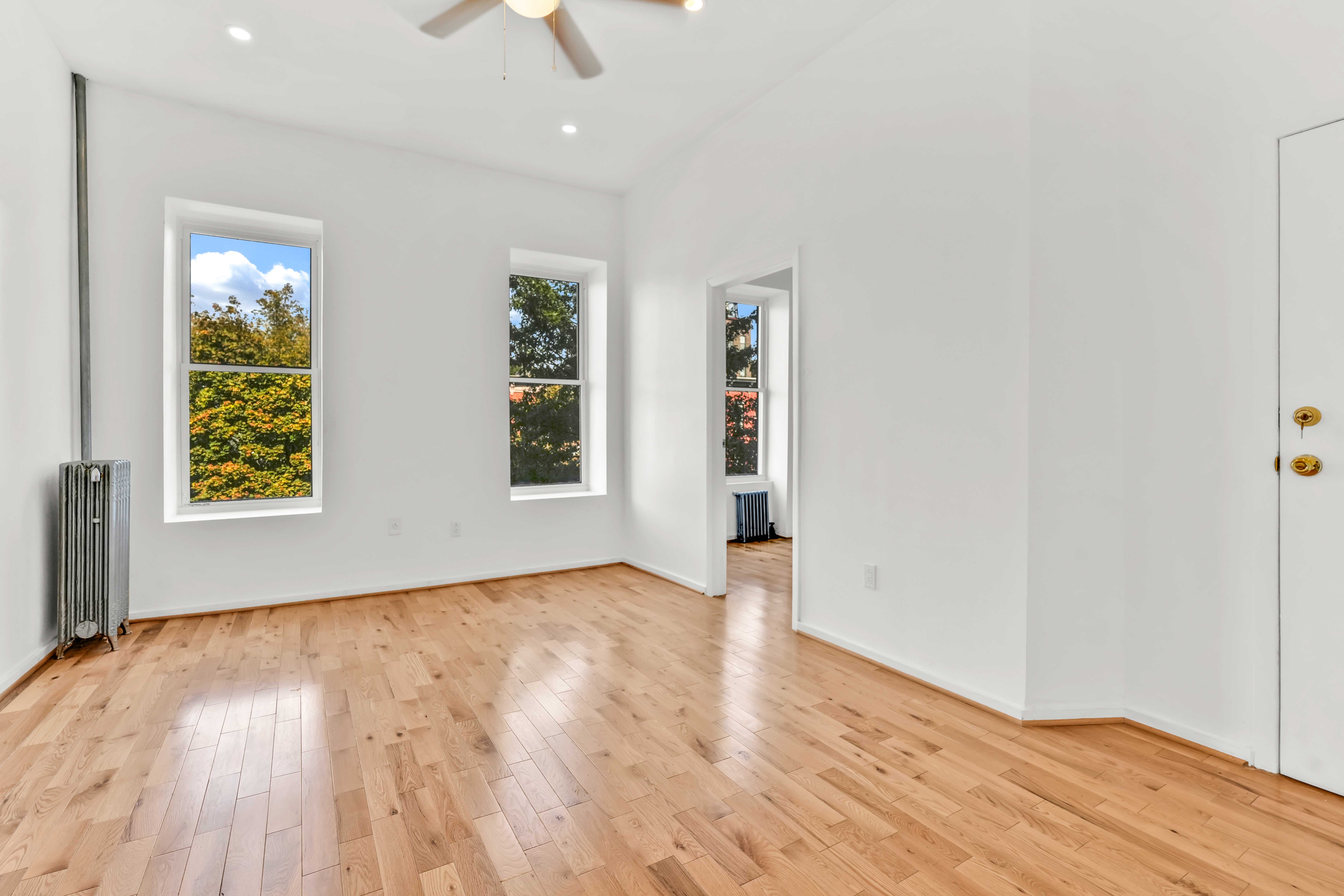 238 Vernon Avenue, Unit 2 Brooklyn, NY 11206 - Photo 4 of 21 wooden floor in an empty room with a window