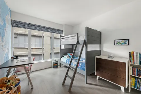 a bedroom with furniture and a window