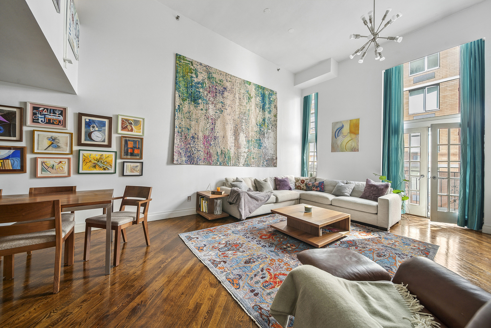 121 West 20th Street, Unit 3C Manhattan, NY 10011 - Photo 2 of 10 a living room with furniture and wooden floor