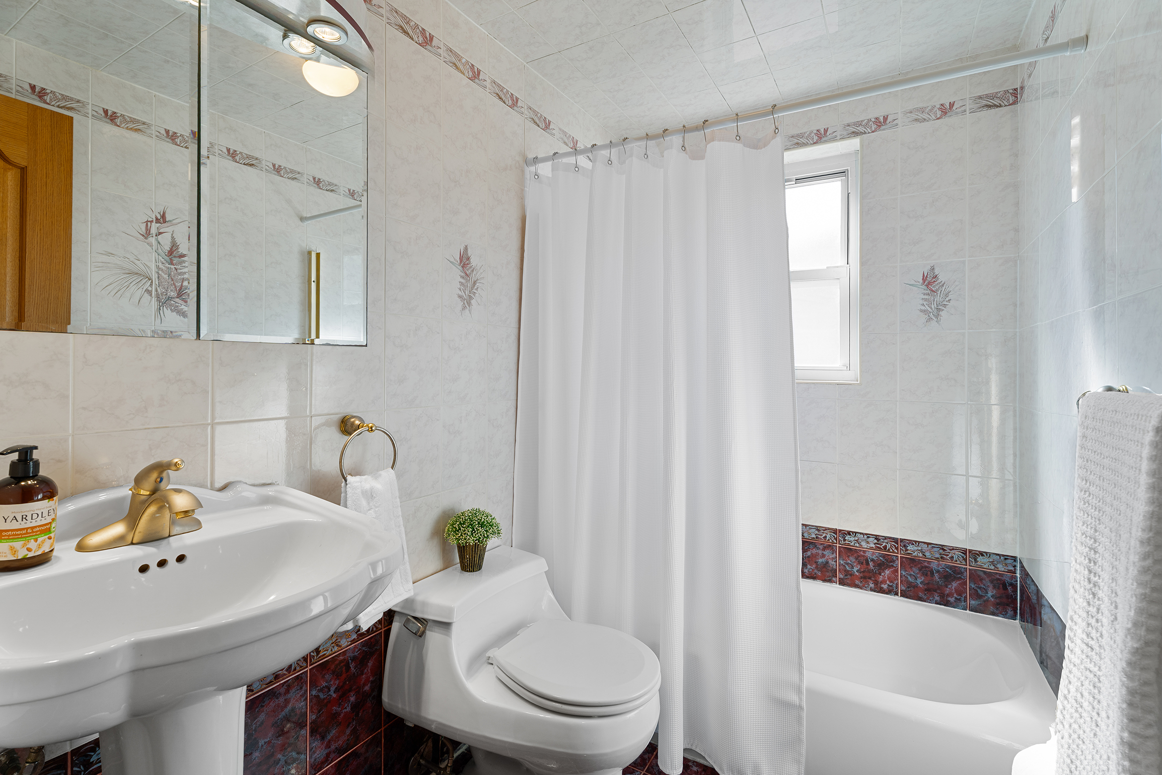 336 99th Street, Unit 15 Brooklyn, NY 11209 - Photo 6 of 7 a bathroom with a sink toilet and shower