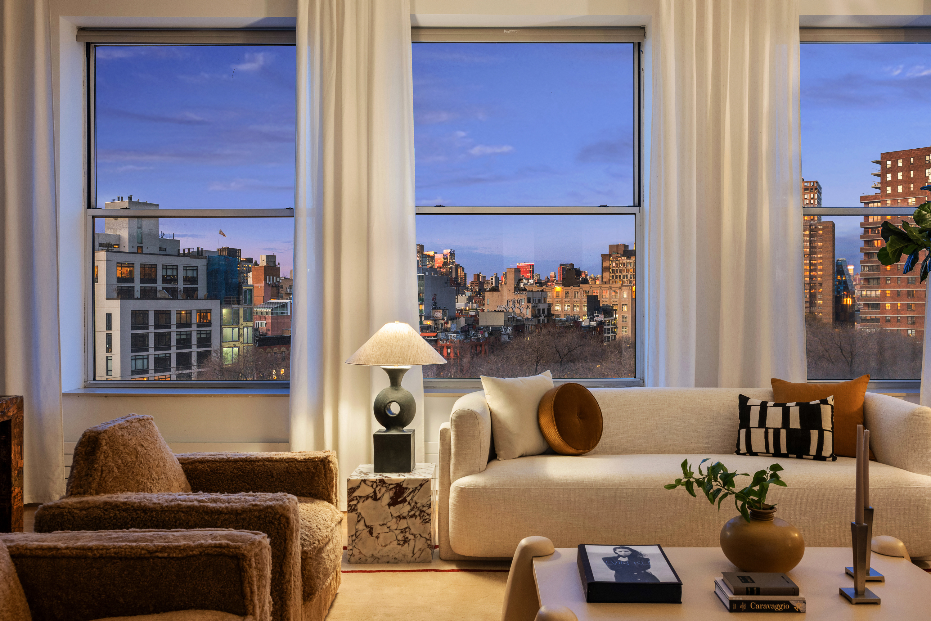 175 East Broadway, Unit 7A Manhattan, NY 10002 - Photo 7 of 24 a living room with furniture and a window