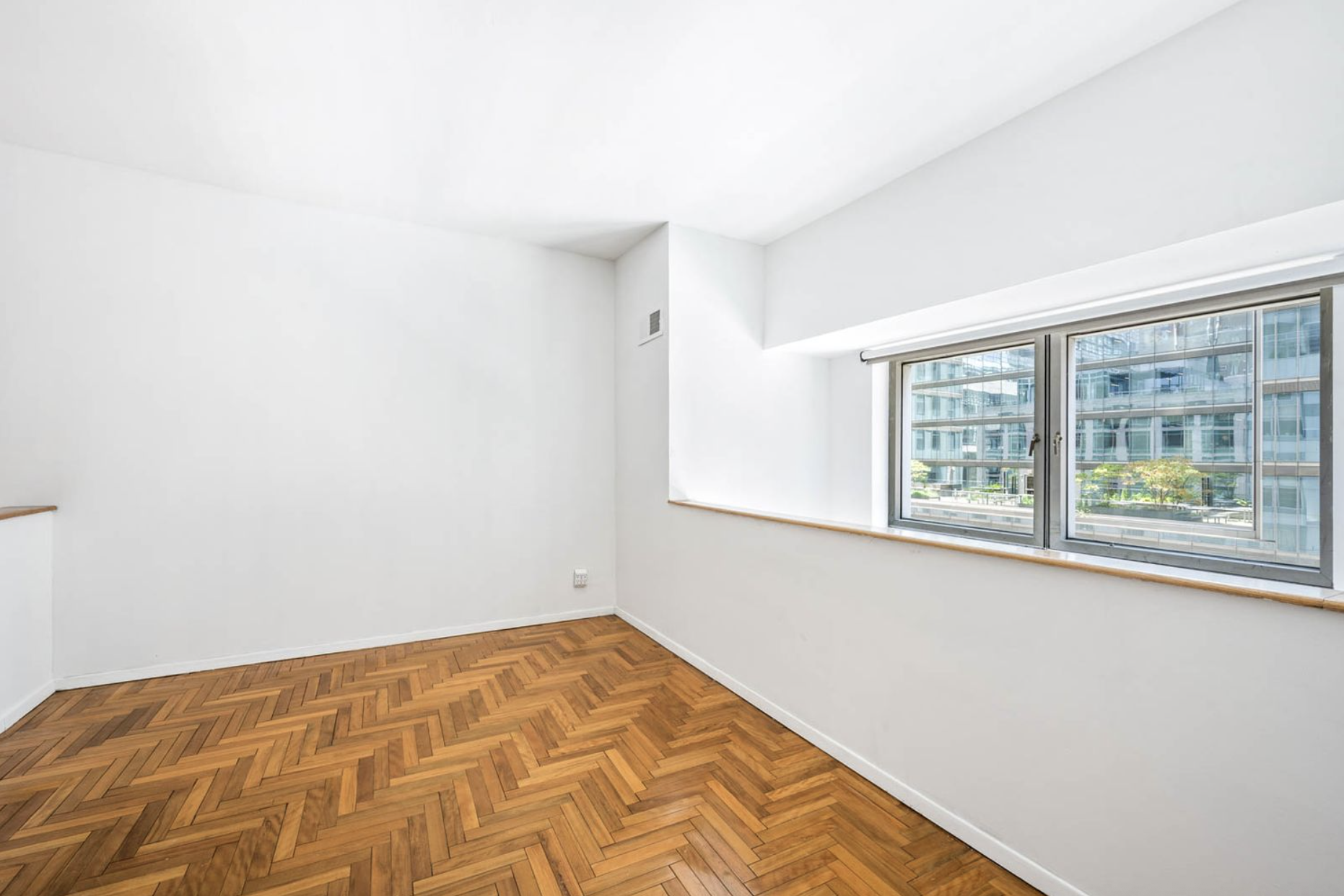 301 West 57th Street, Unit 3E Manhattan, NY 10019 - Photo 6 of 13 a view of empty room with wooden floor and fan
