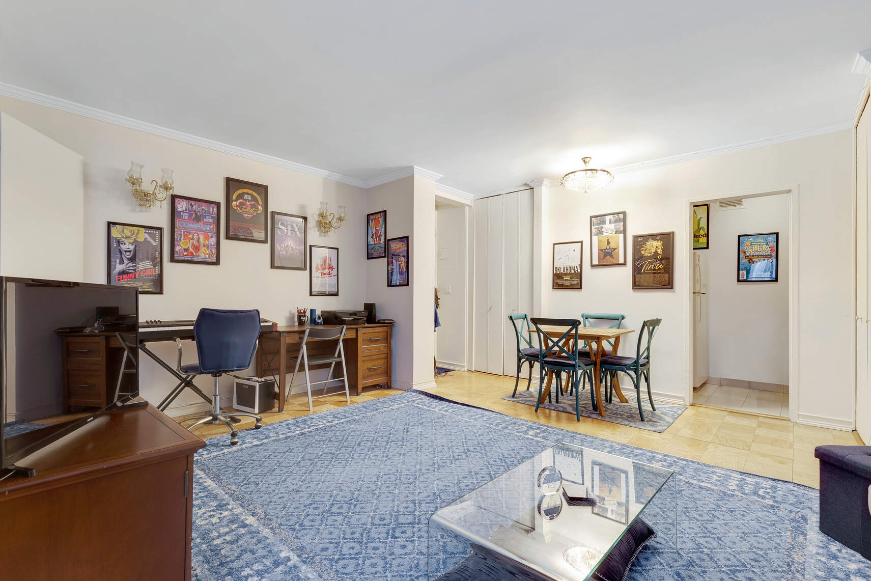 159 West 53rd Street, Unit 18A Manhattan, NY 10019 - Photo 2 of 8 a living room with furniture and a dining table with wooden floor