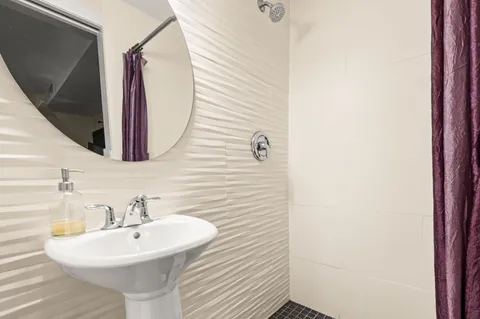 a bathroom with a sink a mirror and vanity