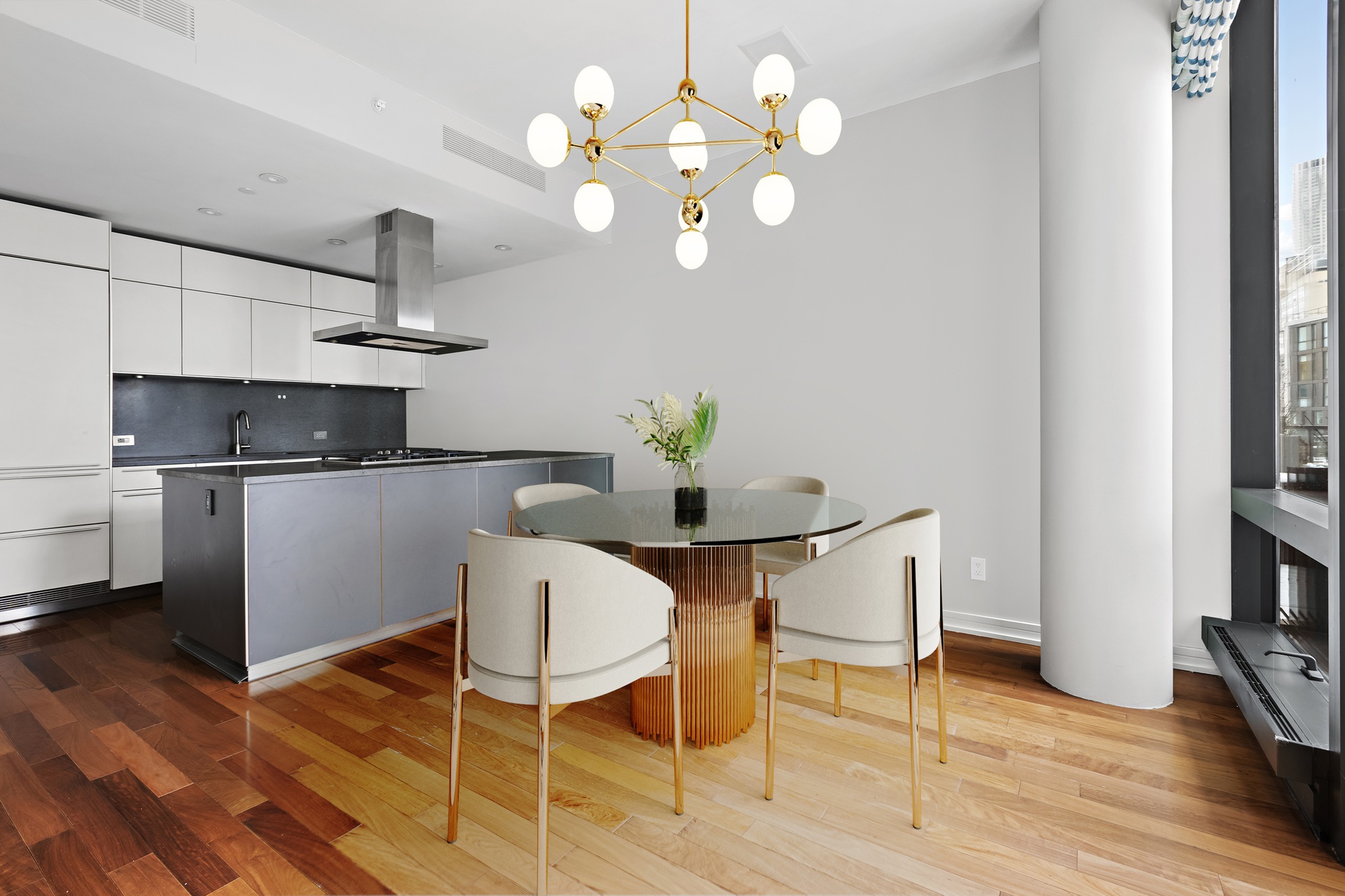 101 Warren Street, Unit 11L Manhattan, NY 10007 - Photo 7 of 26 a kitchen with a dining table chairs and white cabinets