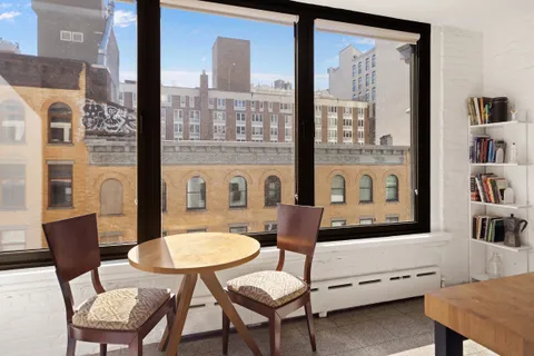 a living room with furniture a rug and a table