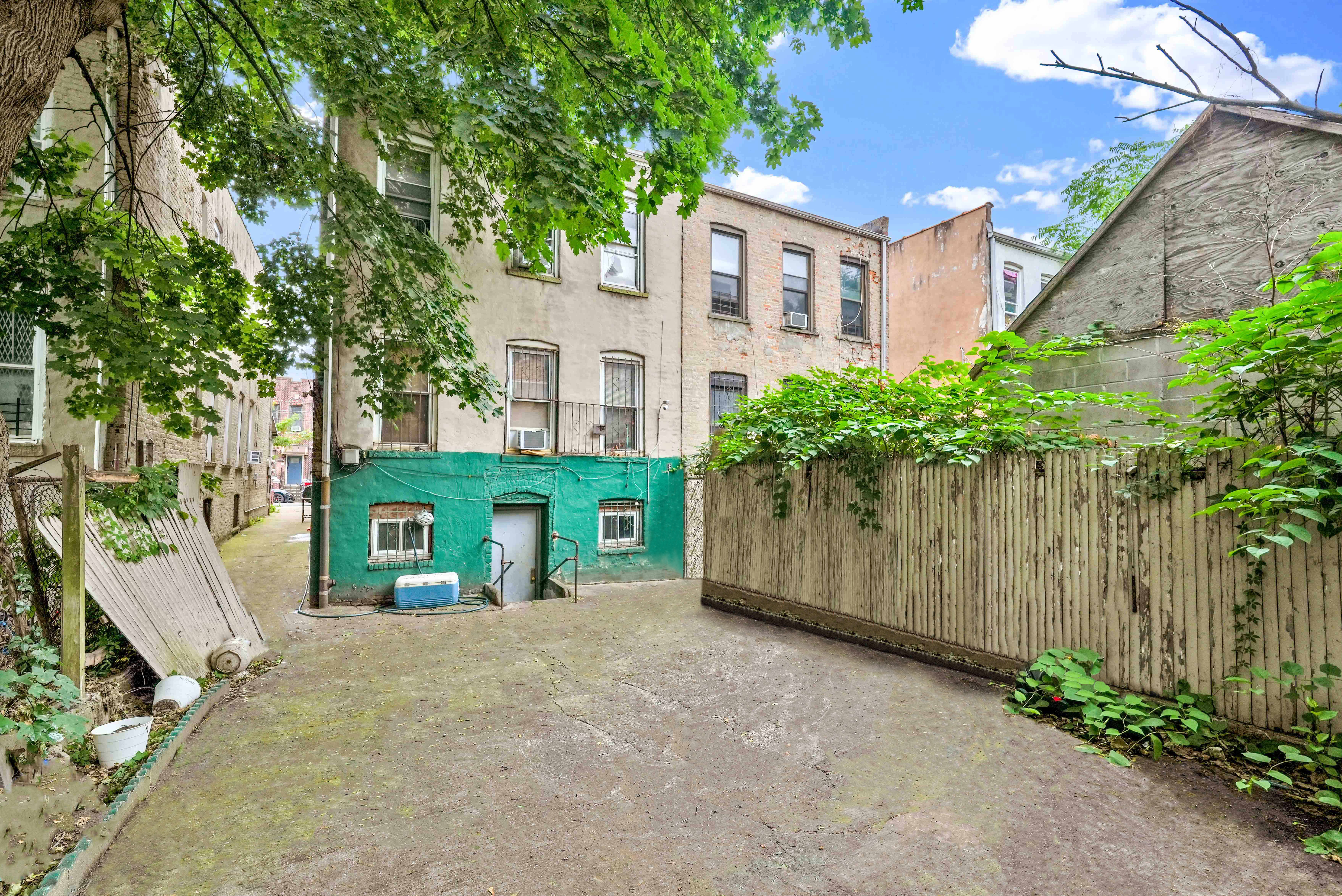 587 Osborn Street Brooklyn, NY 11212 - Photo 5 of 10 a front view of a house with a yard and garage