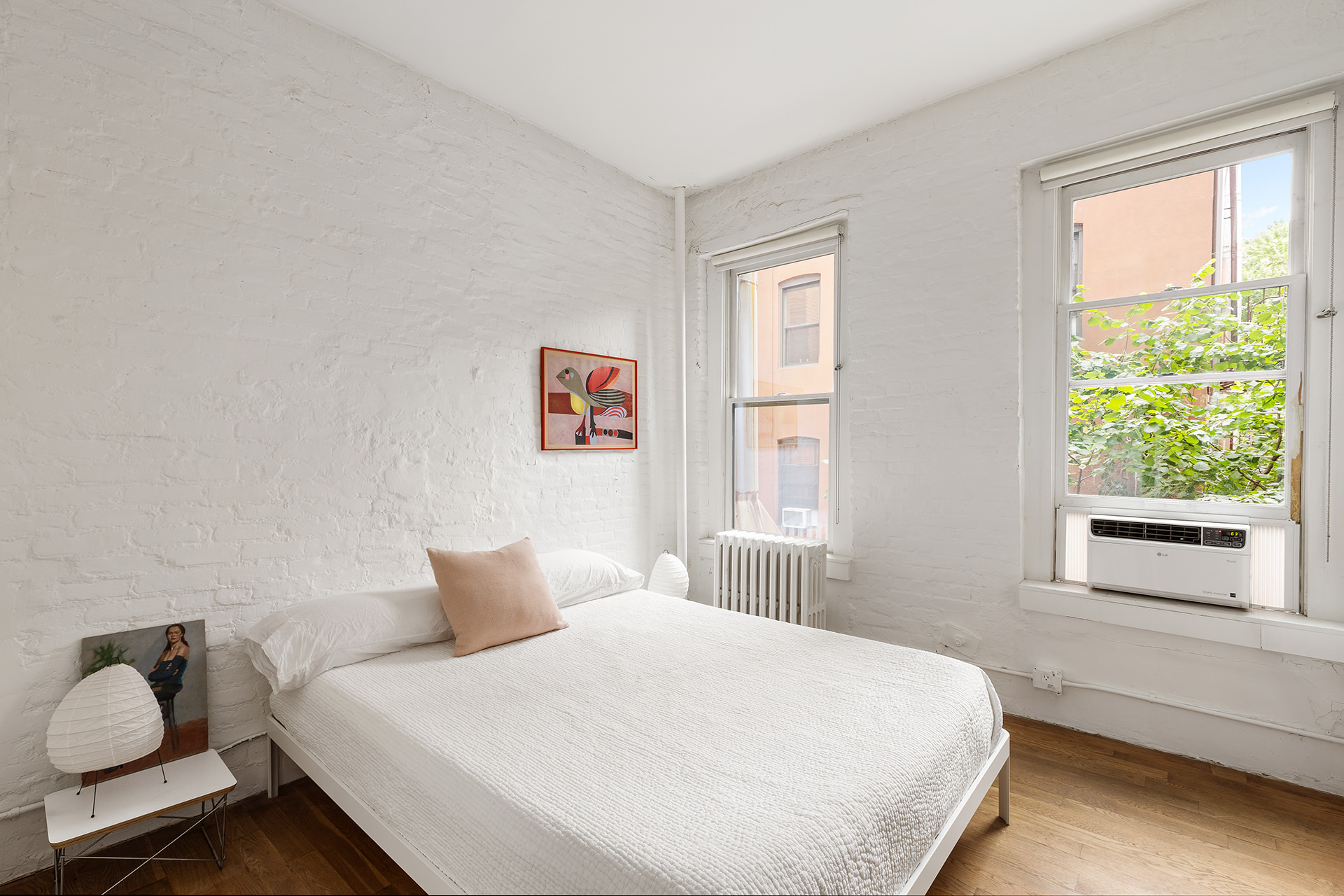305 East 4th Street, Unit 2 Manhattan, NY 10009 - Photo 5 of 11 a bedroom with a bed and wooden floor
