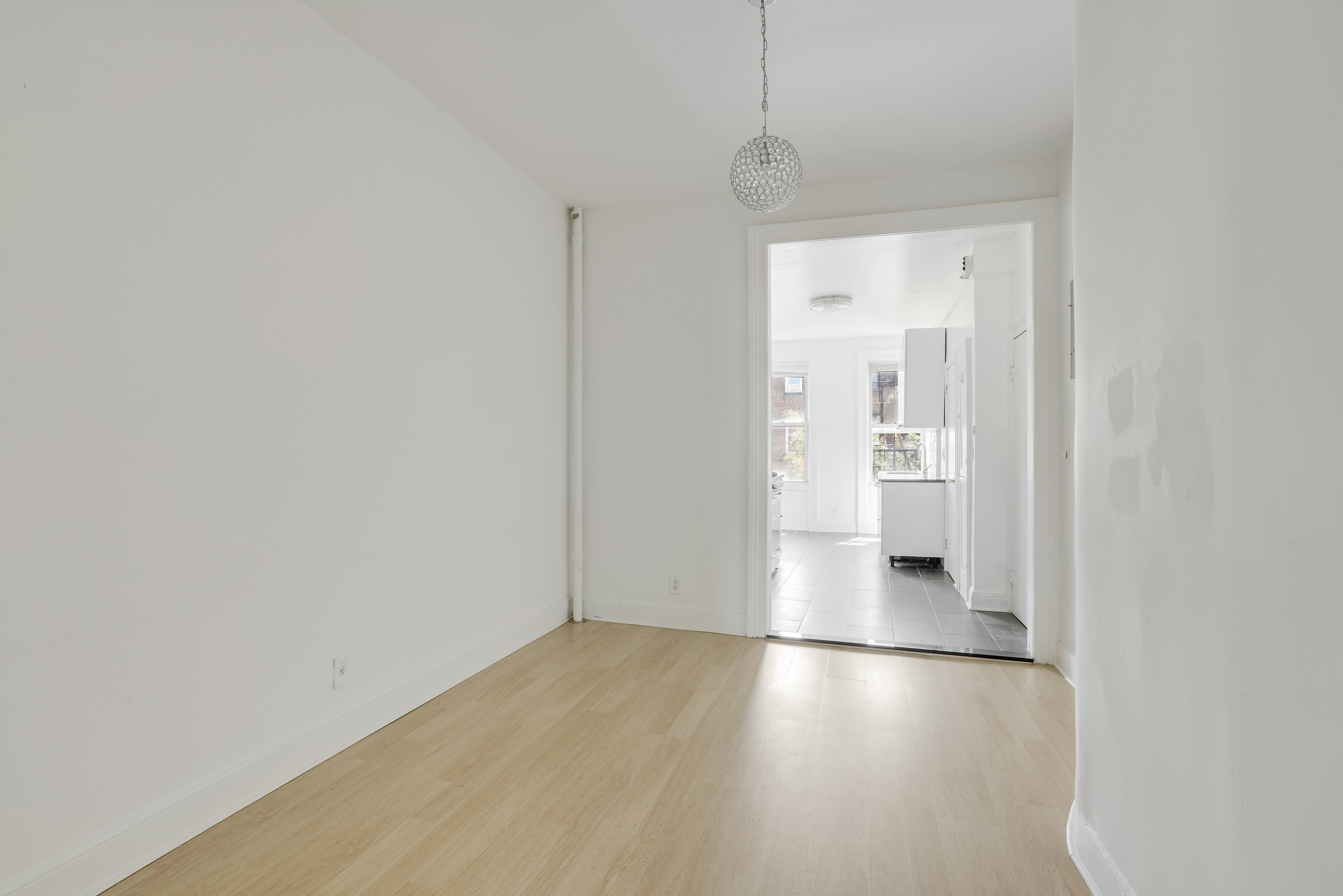 100 Powers Street, Unit 3L Brooklyn, NY 11211 - Photo 12 of 17 a view of a room with wooden floor and a window