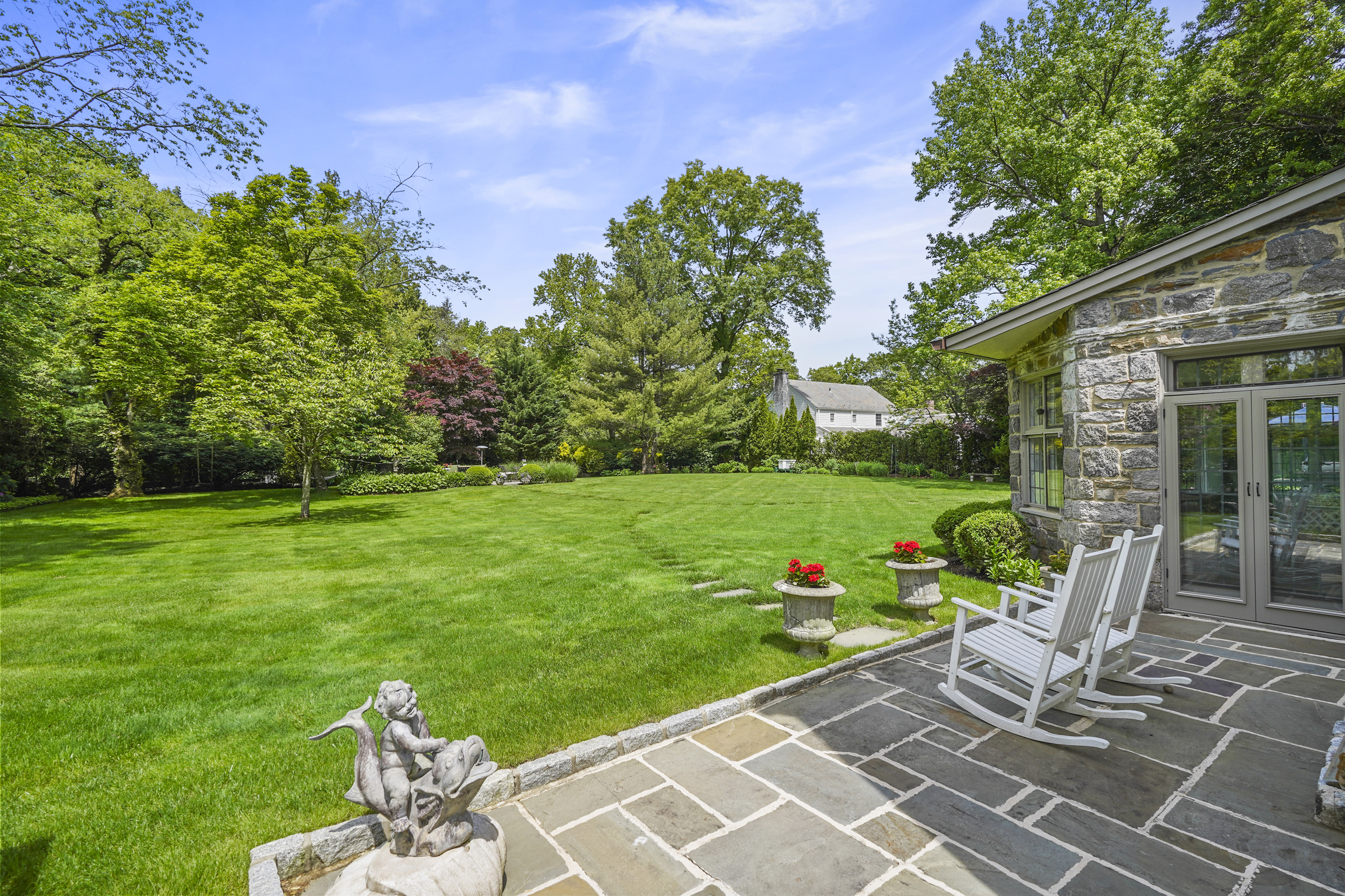 19 Avon Road Larchmont, NY 10538 - Photo 27 of 35 a view of a table and chairs in the garden