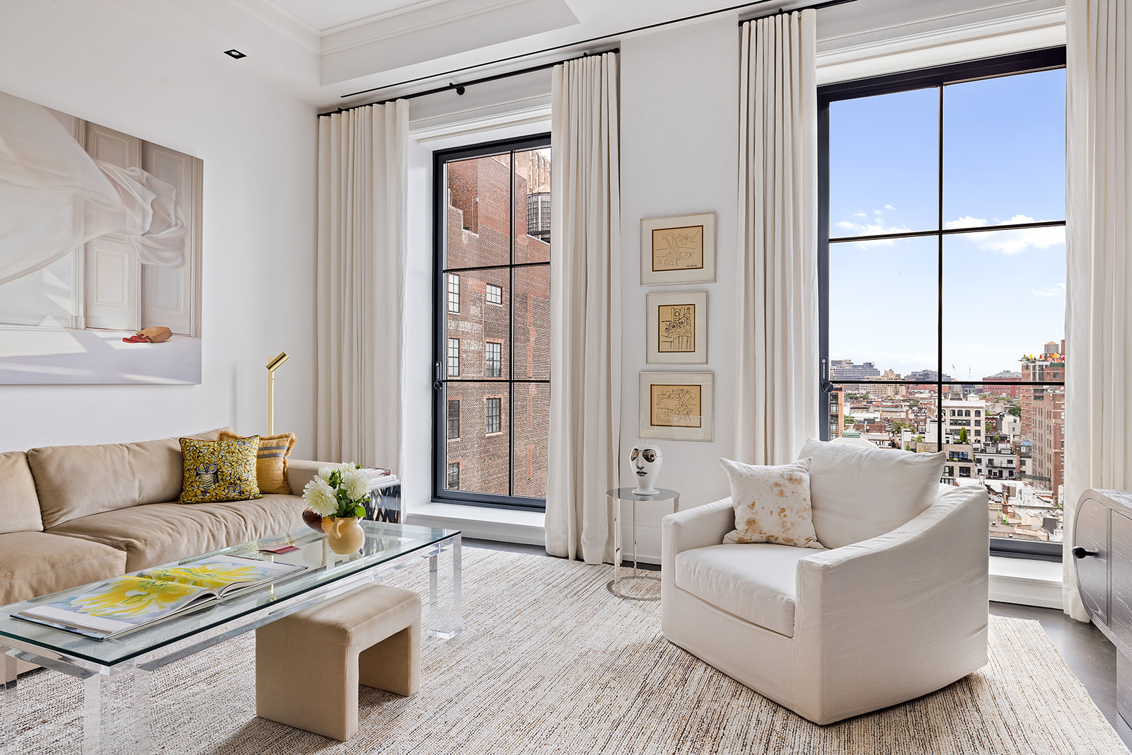 212 West 18th Street, Unit 9C Manhattan, NY 10011 - Photo 2 of 10 a living room with furniture and a large window