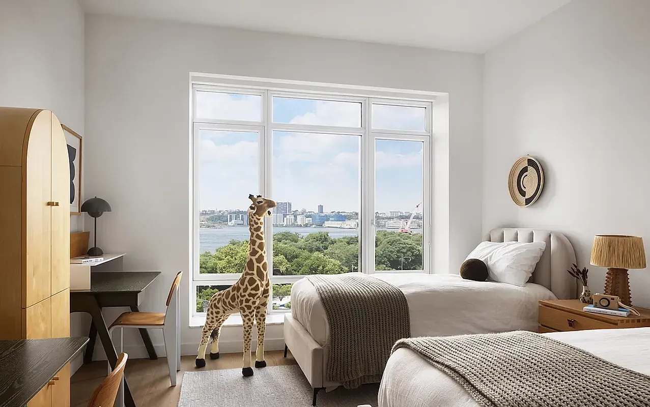 a bedroom with two beds and a large window