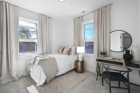 a bedroom with bed and a window