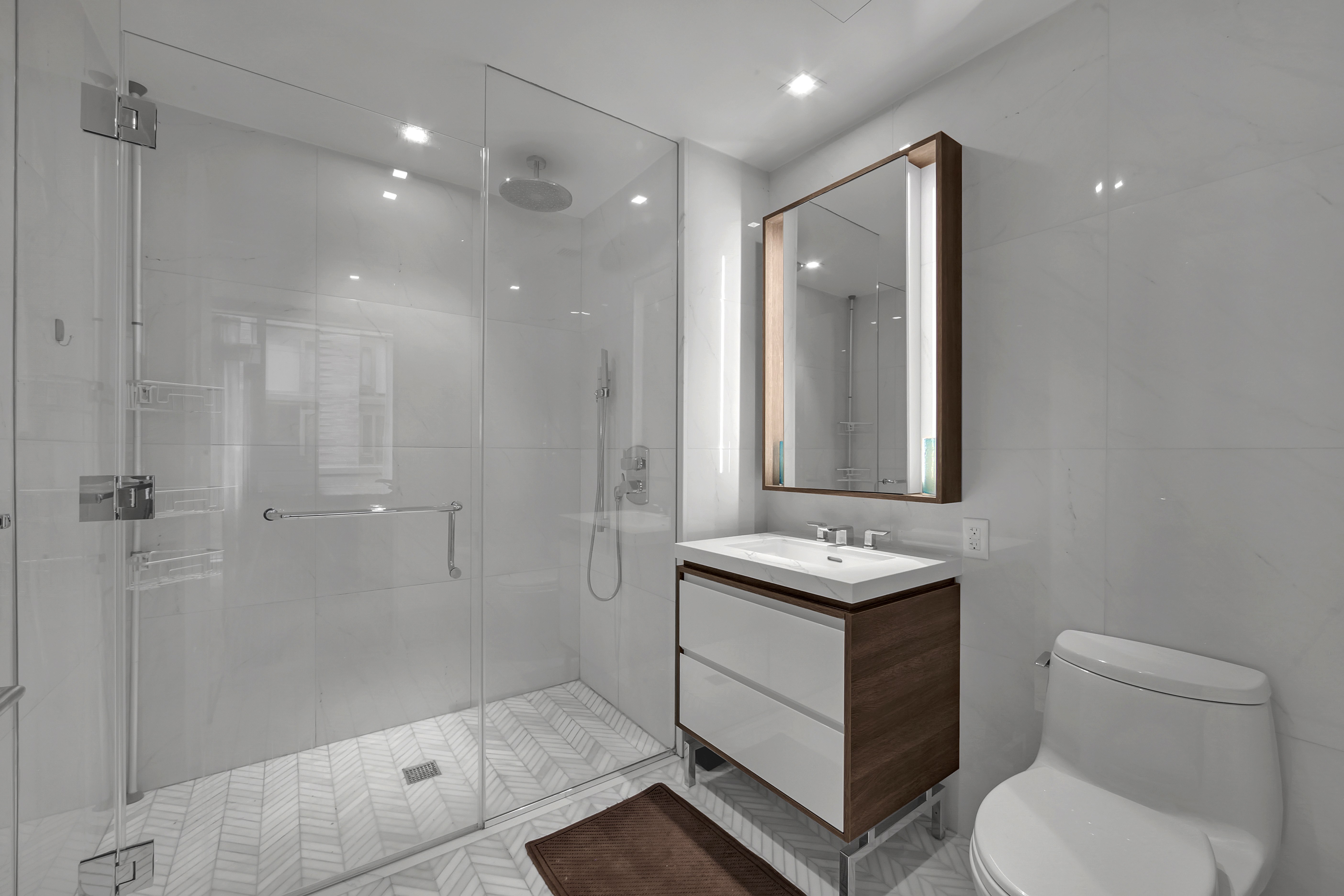 505-513 West 43rd Street, Unit 3M Manhattan, NY 10036 - Photo 9 of 20 a bathroom with a sink toilet and shower