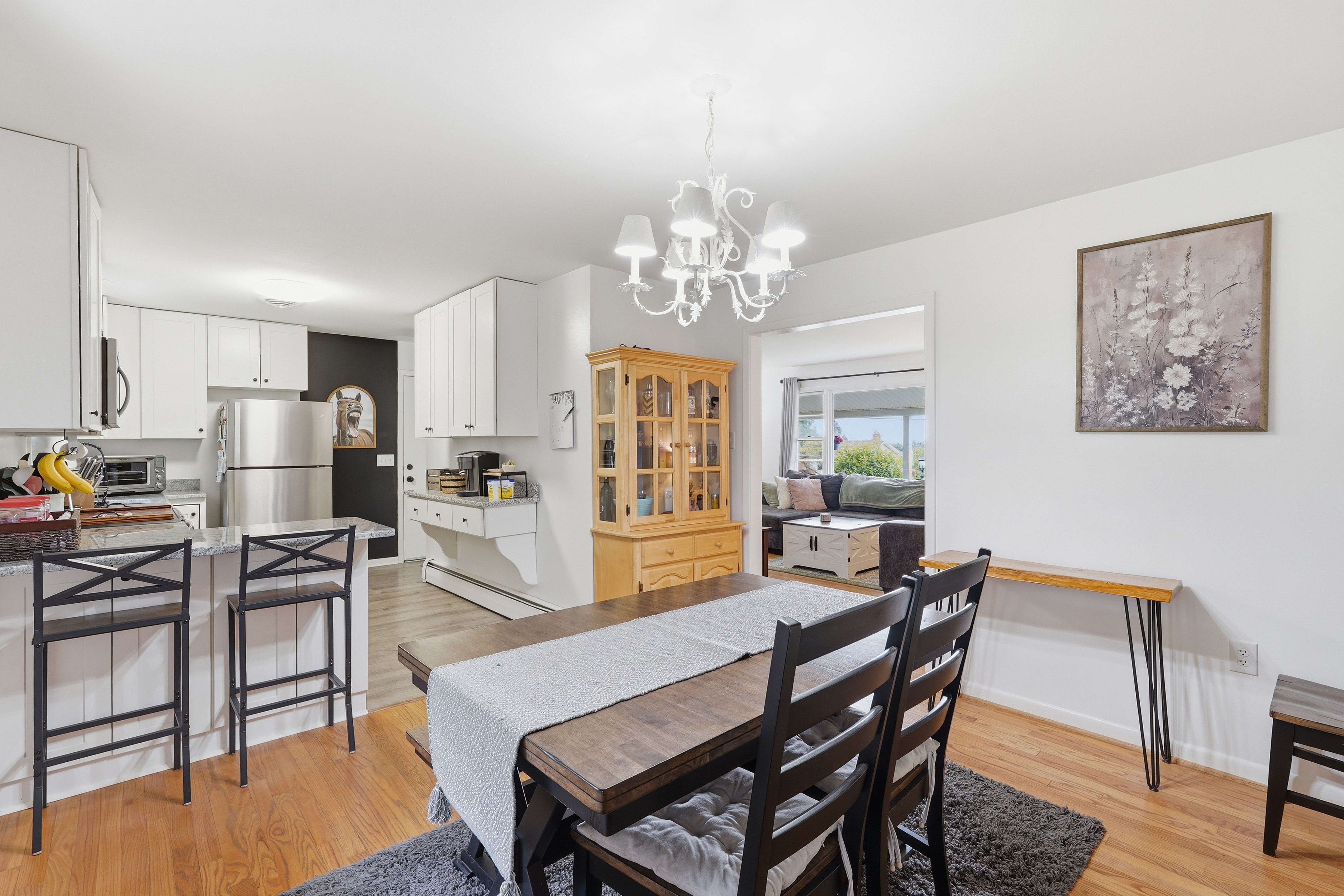 7717 McKaig Road Frederick, MD 21701 - Photo 15 of 53 a dining room with furniture a chandelier and wooden floor