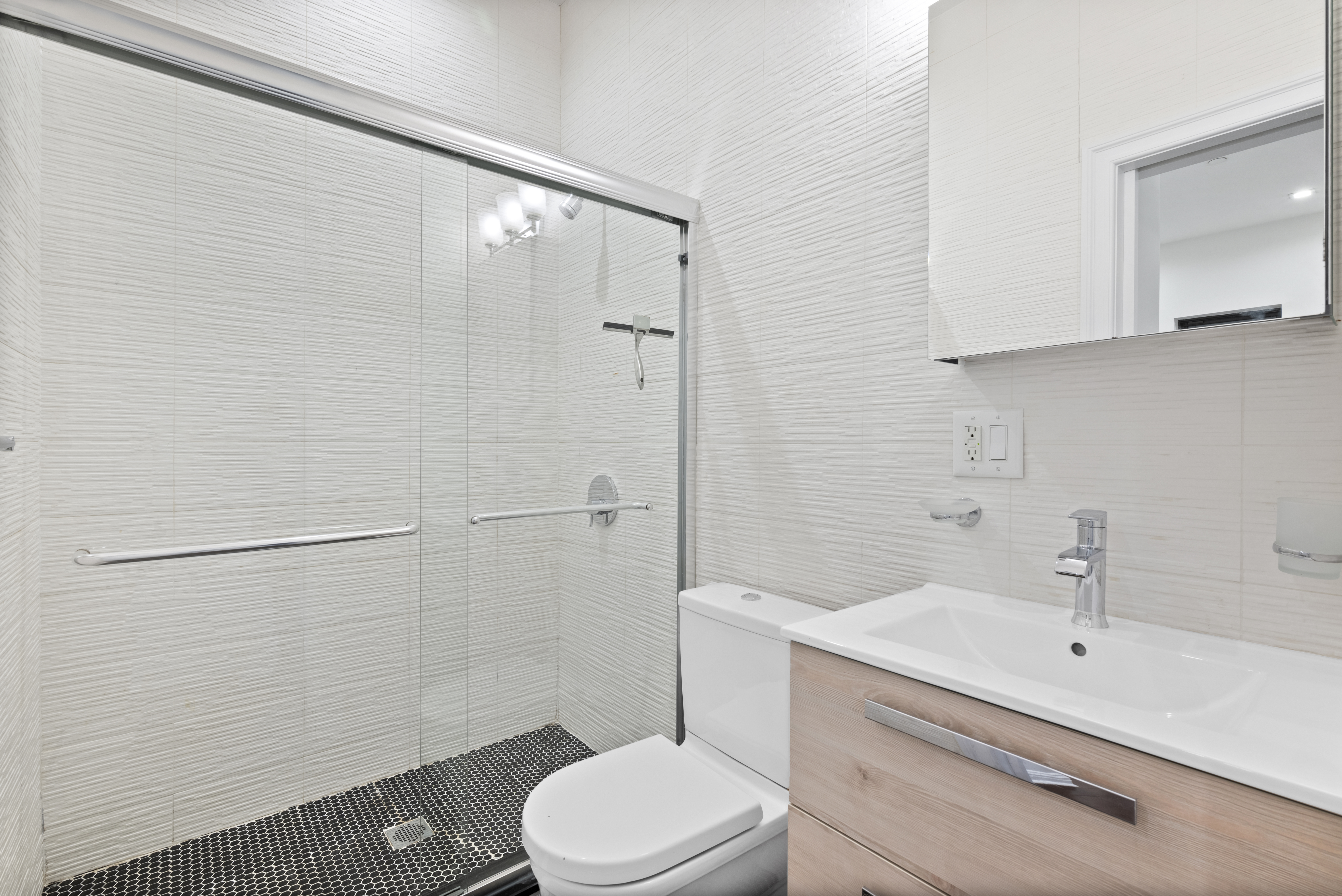 31 St Marks Place, Unit 10 Manhattan, NY 10003 - Photo 3 of 8 a bathroom with a sink a toilet and shower