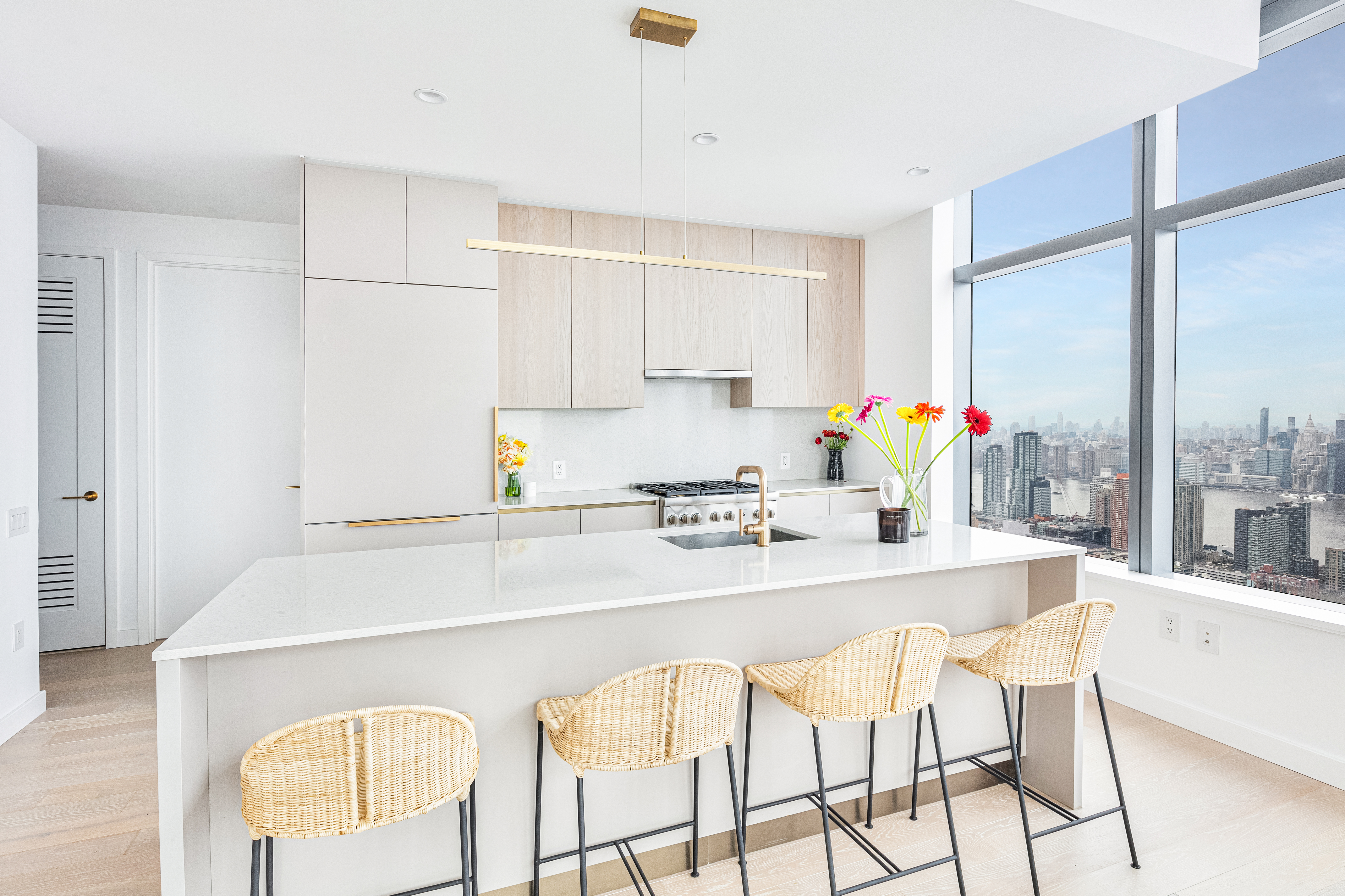 45-3 Ct Square West, Unit PH202 Queens, NY 11101 - Photo 2 of 12 a kitchen with a stove a table and chairs in it