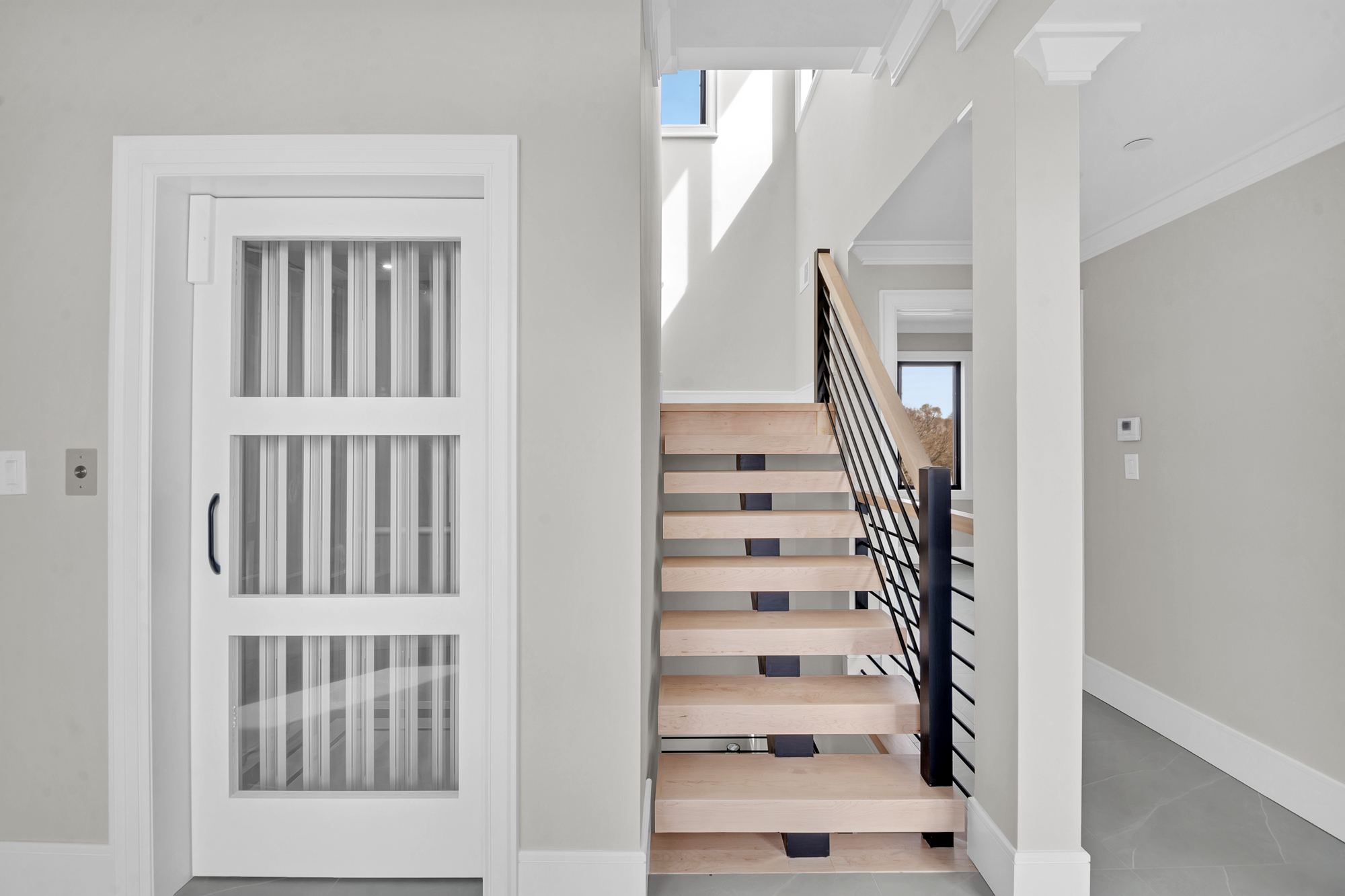 5 Osprey Court Staten Island, NY 10308 - Photo 6 of 50 a view of staircase with lots of frames on wall and a window