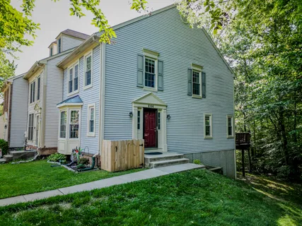 a front view of a house with a garden