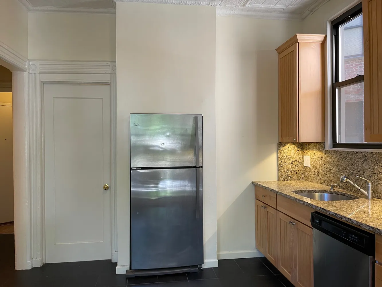 a kitchen with stainless steel appliances granite countertop a refrigerator and a sink