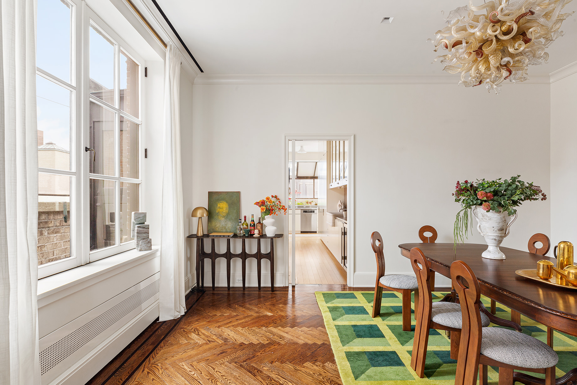 14 East 90th Street, Unit PHW Manhattan, NY 10128 - Photo 9 of 25 a view of a dining room with furniture a potted plant and wooden floor