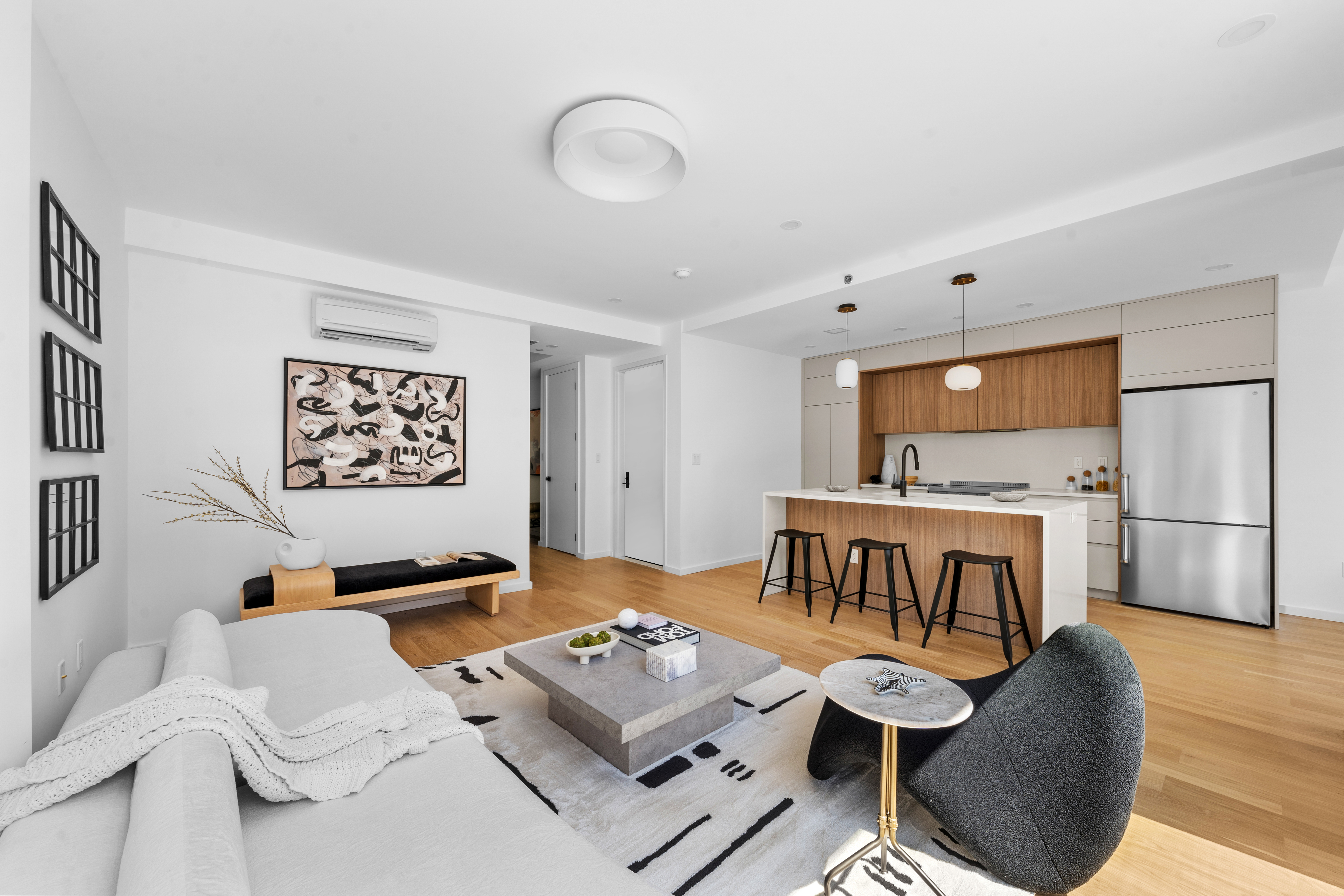 14-35 Broadway, Unit PH Queens, NY 11106 - Photo 1 of 24 a living room with furniture and a flat screen tv