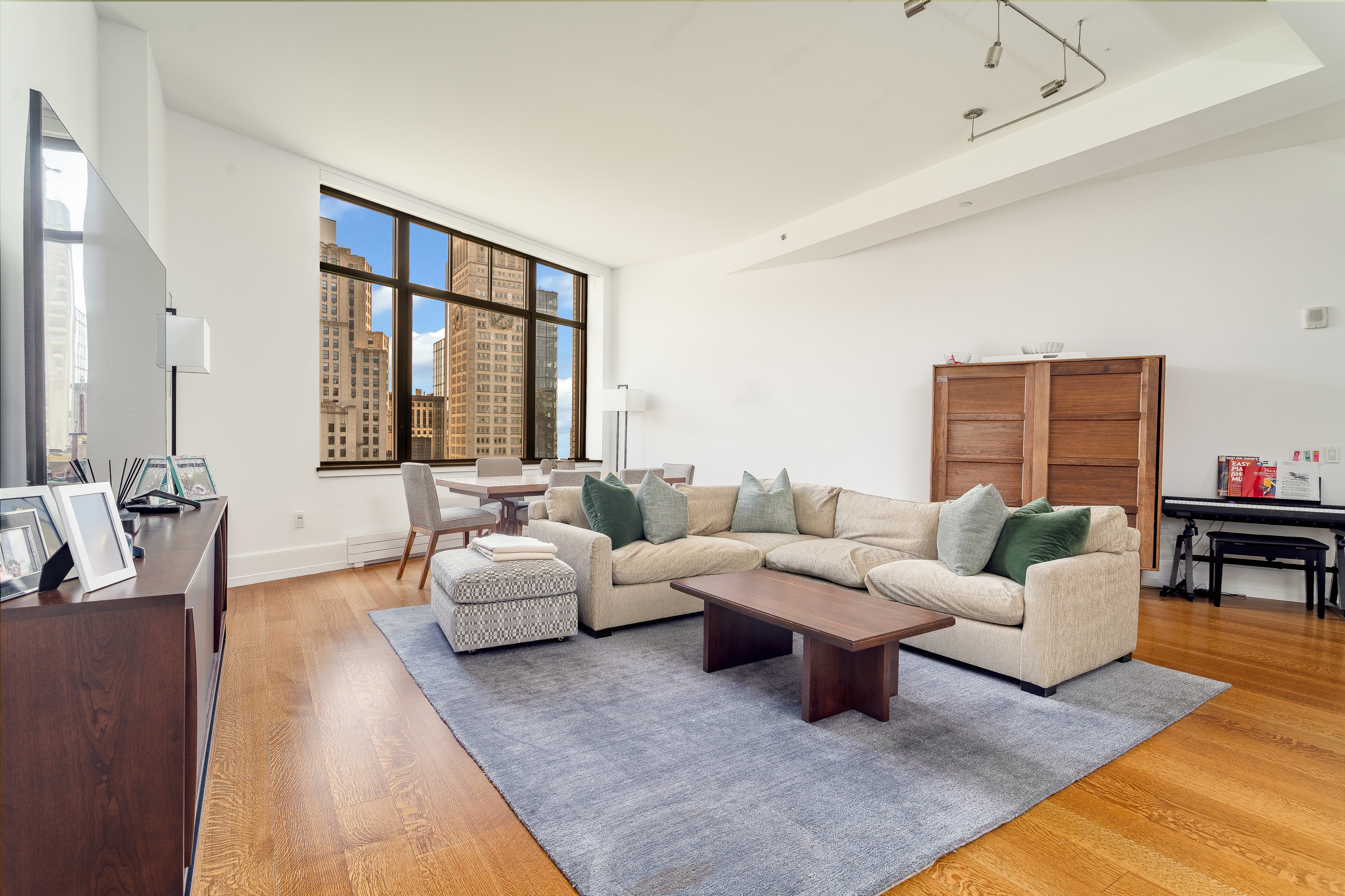 10 Madison Square West, Unit 16F Manhattan, NY 10010 - Photo 3 of 15 a living room with furniture or couch and a large window