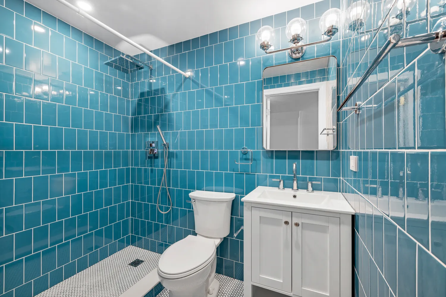 a bathroom with a sink mirror toilet and shower