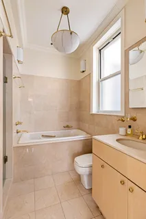 a bathroom with a sink a toilet and bathtub
