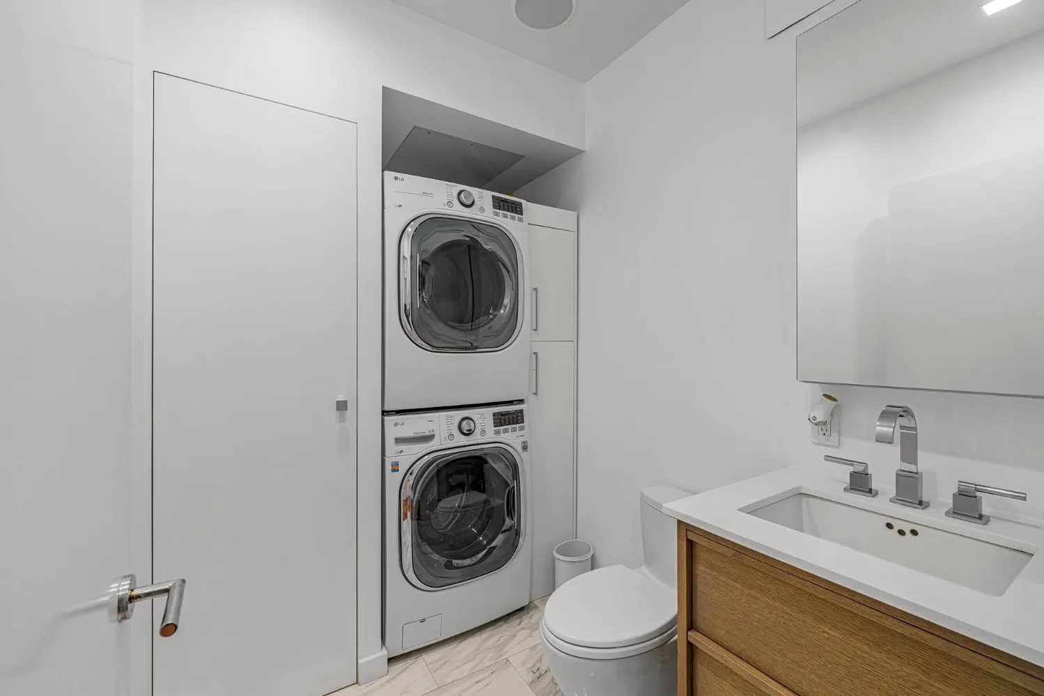a utility room with sink dryer and washer