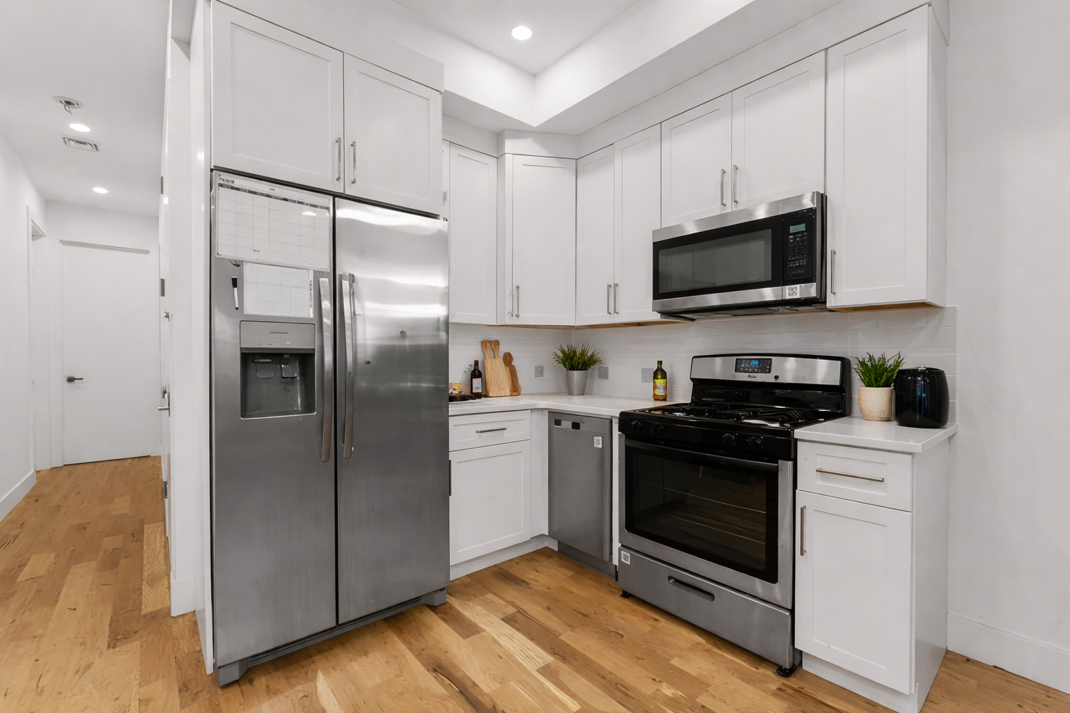 1409 Greene Avenue, Unit 2 Brooklyn, NY 11237 - Photo 6 of 11 a kitchen with stainless steel appliances a refrigerator sink and microwave