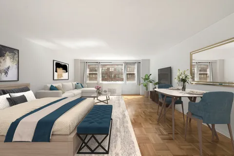 a living room with a couch a table and a window