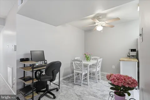 a dining room with furniture and chandelier