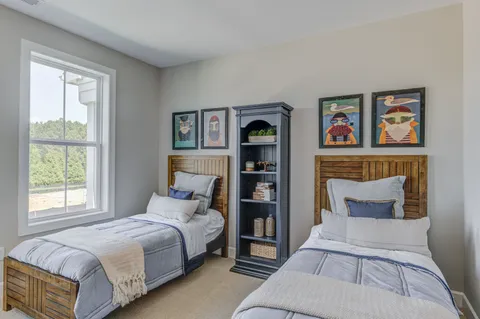 a bedroom with a bed and painting on the wall