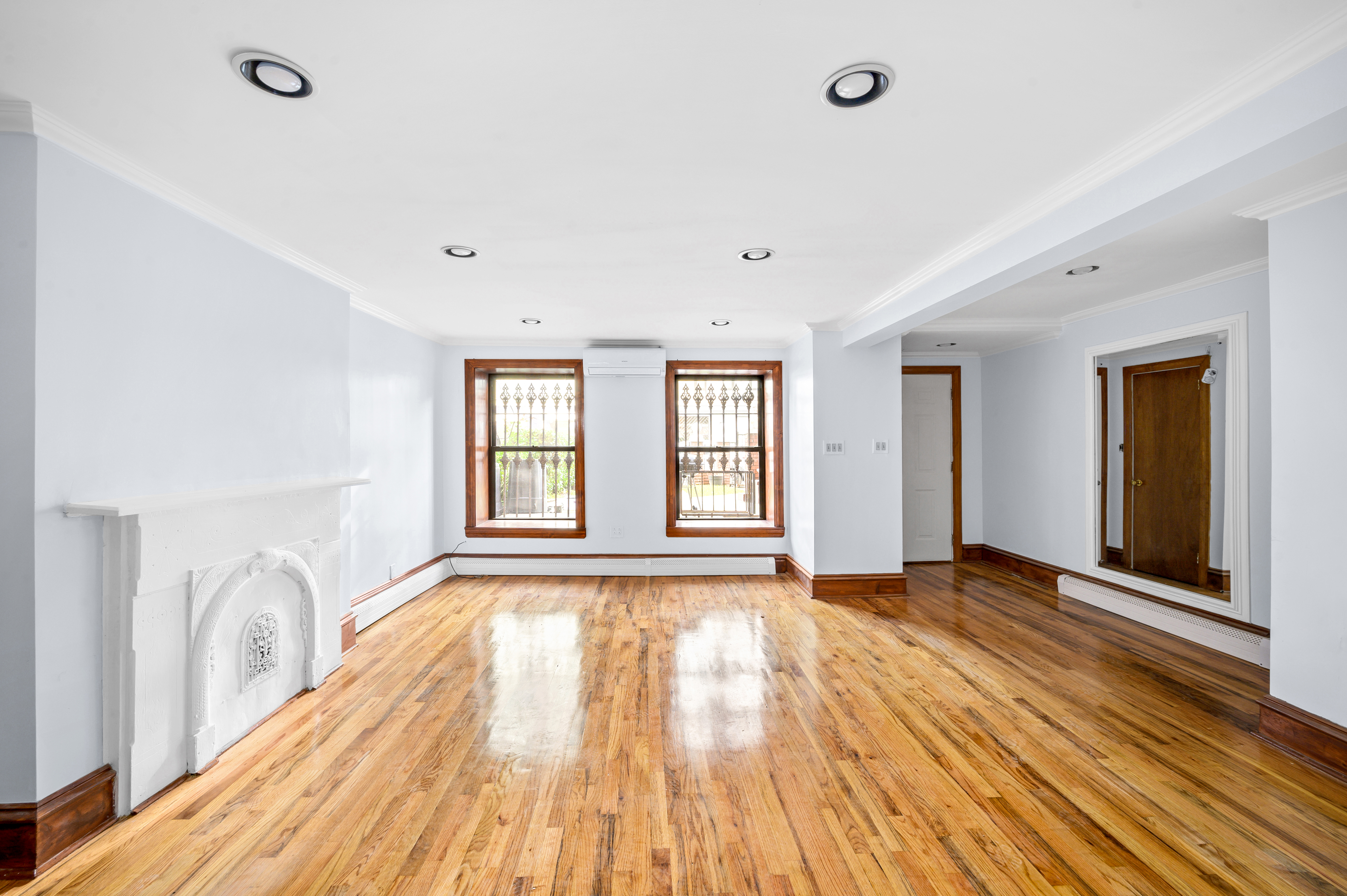 808 Lexington Avenue, Unit 1 Brooklyn, NY 11221 - Photo 2 of 8 a view of an empty room with wooden floor and a window