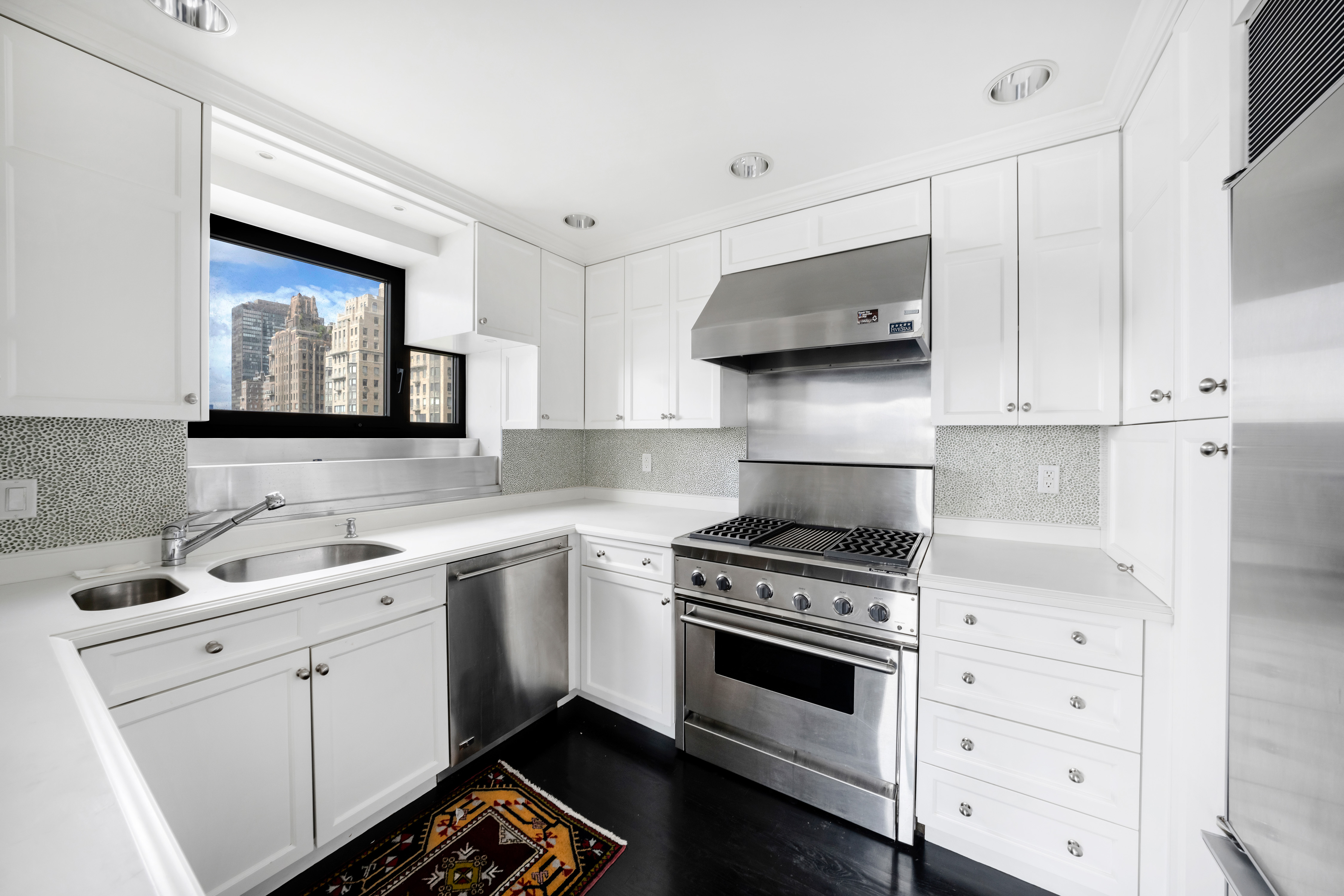 45 Sutton Place South, Unit 8L Manhattan, NY 10022 - Photo 6 of 22 a kitchen with cabinets appliances and a sink