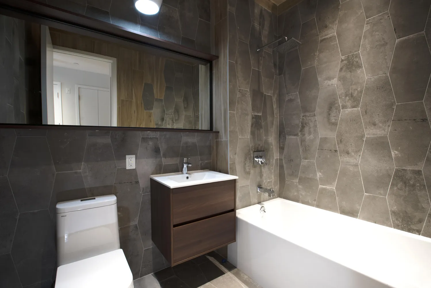 a bathroom with a sink a toilet and mirror