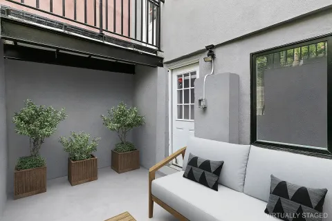 a hallway with a couch and a potted plant