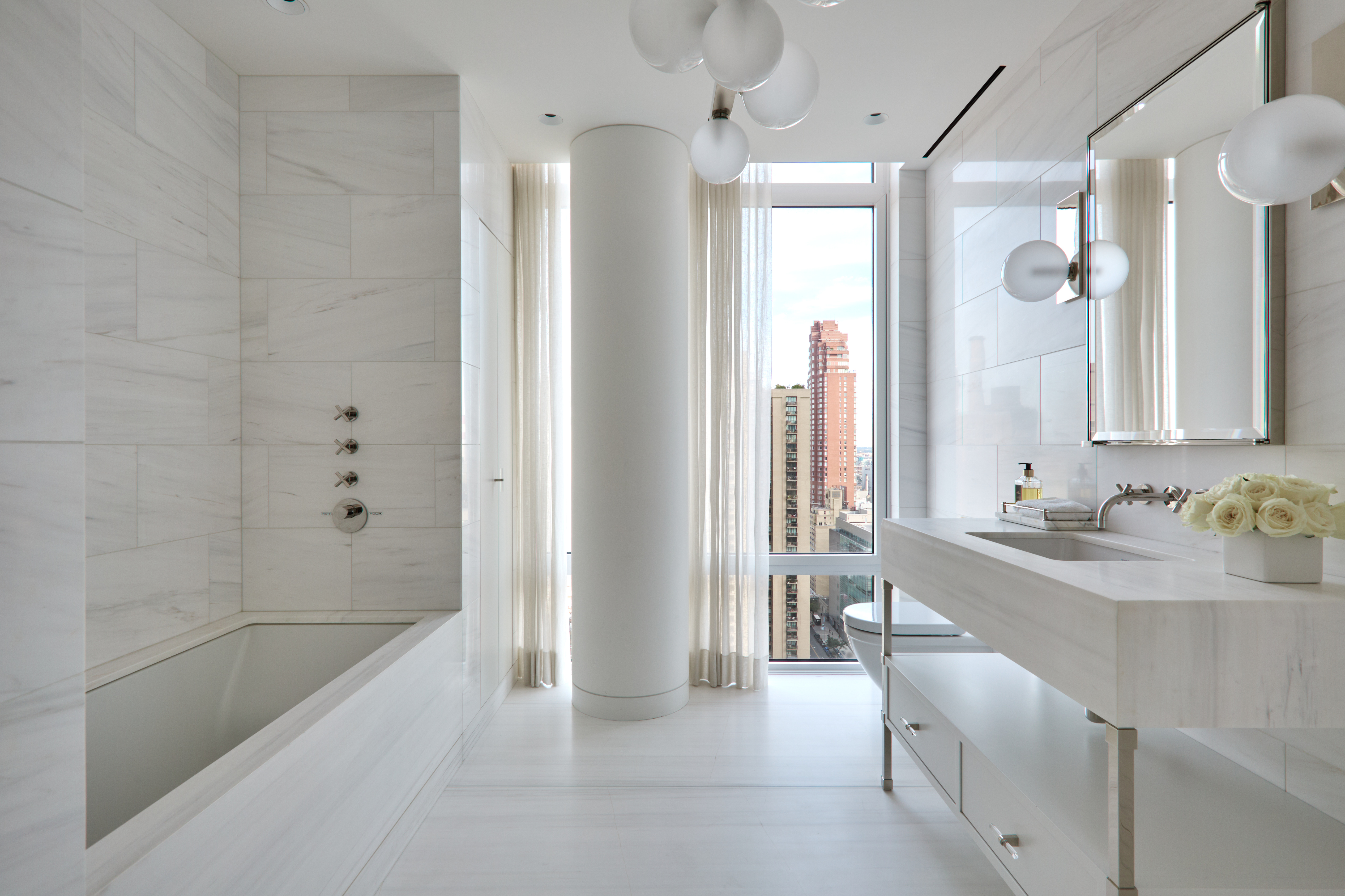 1355 1st Avenue, Unit PH2 Manhattan, NY 10021 - Photo 25 of 28 a spacious bathroom with a bathtub sink and mirror