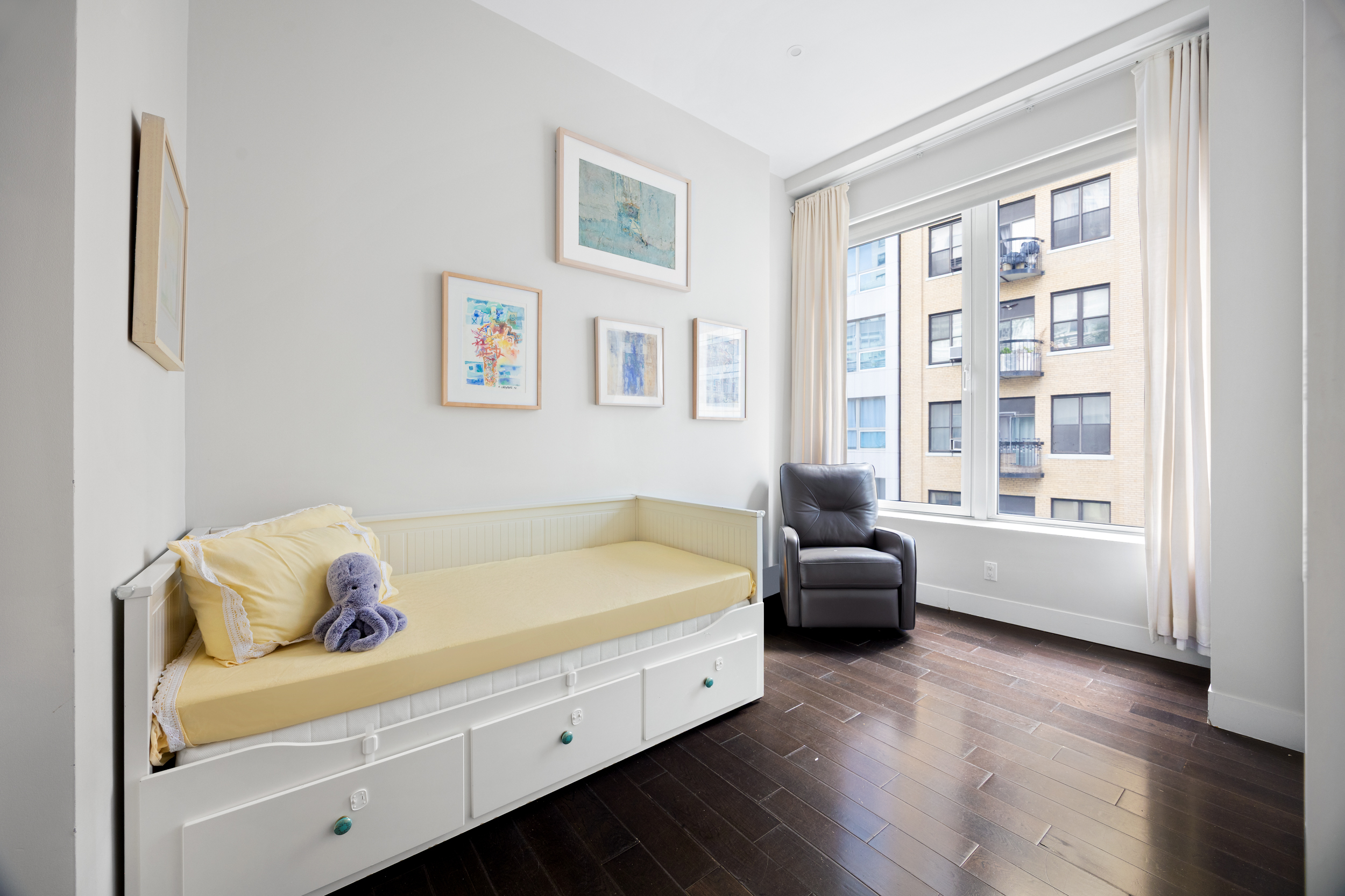 111 Fulton Street, Unit 824 Manhattan, NY 10038 - Photo 10 of 35 a spacious bedroom with a bed and wooden floor