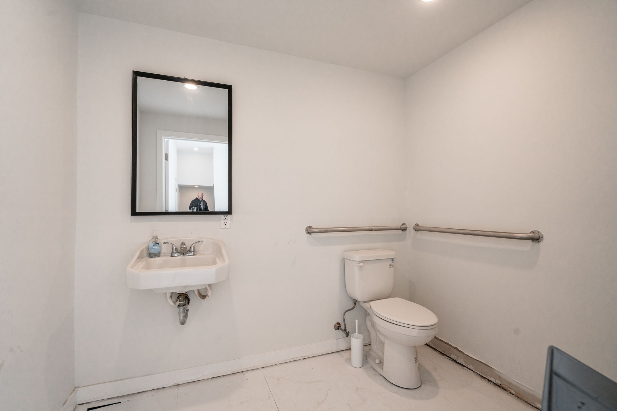 2609 Federal Street, Unit COMMERCIAL Philadelphia, PA 19146 - Photo 15 of 22 a bathroom with a toilet sink and mirror