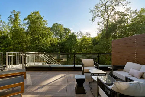 a balcony with table and chairs