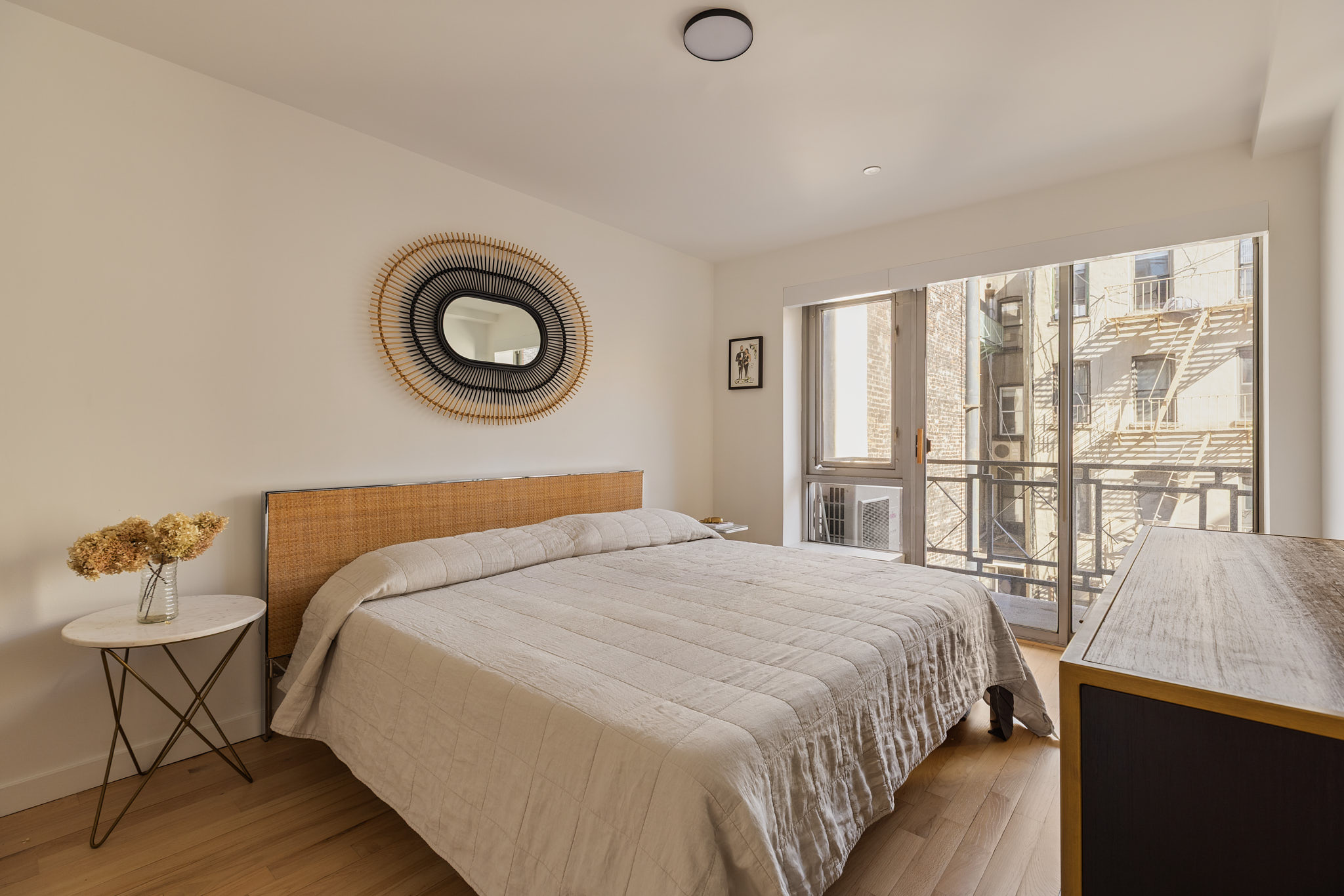 182 Mulberry Street, Unit 4 Manhattan, NY 10012 - Photo 8 of 13 a bedroom with a bed and a window
