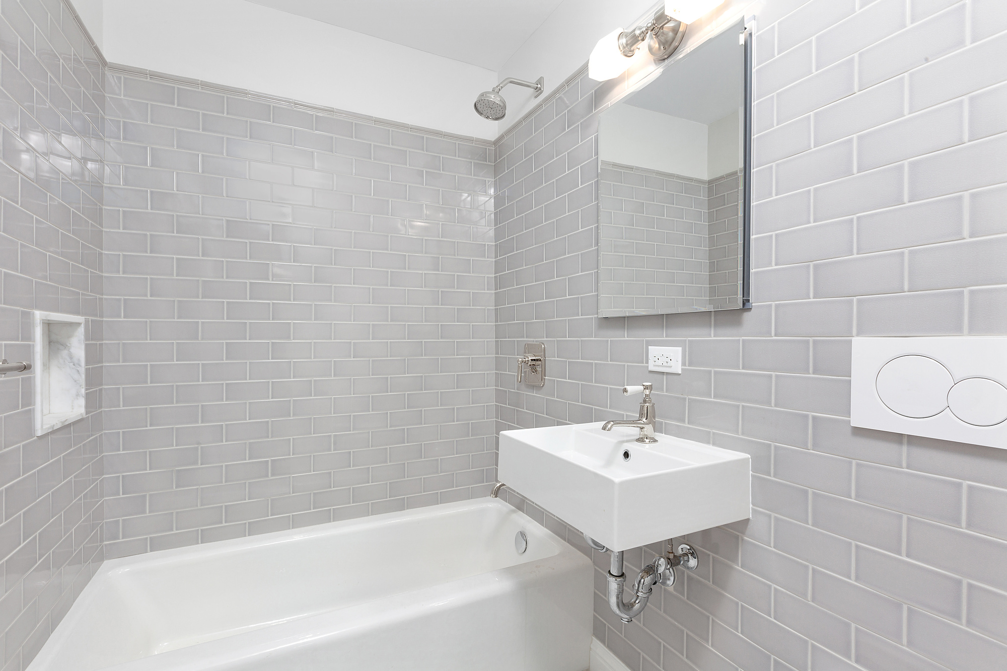 522 East 82nd Street, Unit 1 Manhattan, NY 10028 - Photo 15 of 16 a white bath tub sitting next to a white sink