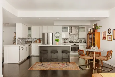 a kitchen with a sink cabinets and window