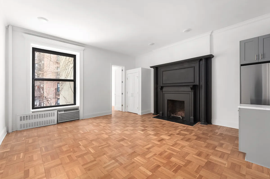 134 West 80th Street, Unit 2R Manhattan, NY 10024 - Photo 1 of 7 a view of an empty room with a fireplace and a window