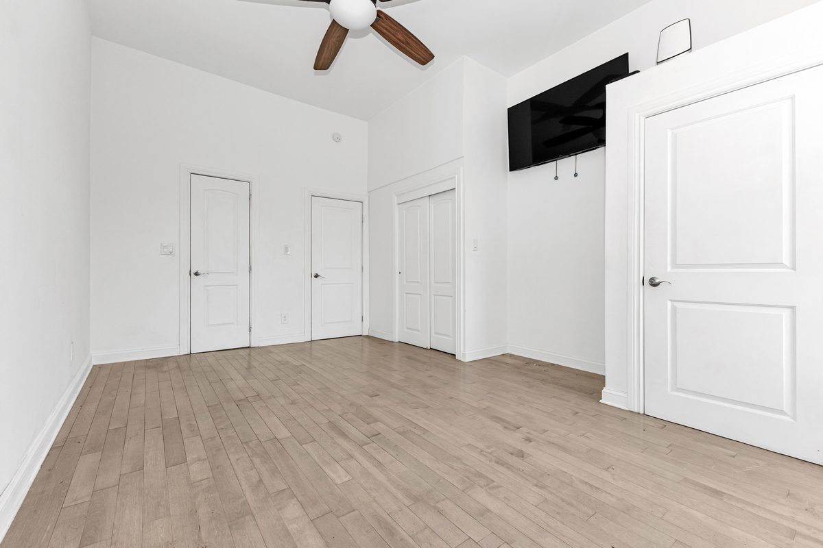 521 Dean Street, Unit 9 Brooklyn, NY 11217 - Photo 4 of 12 a view of empty room with wooden floor and fan