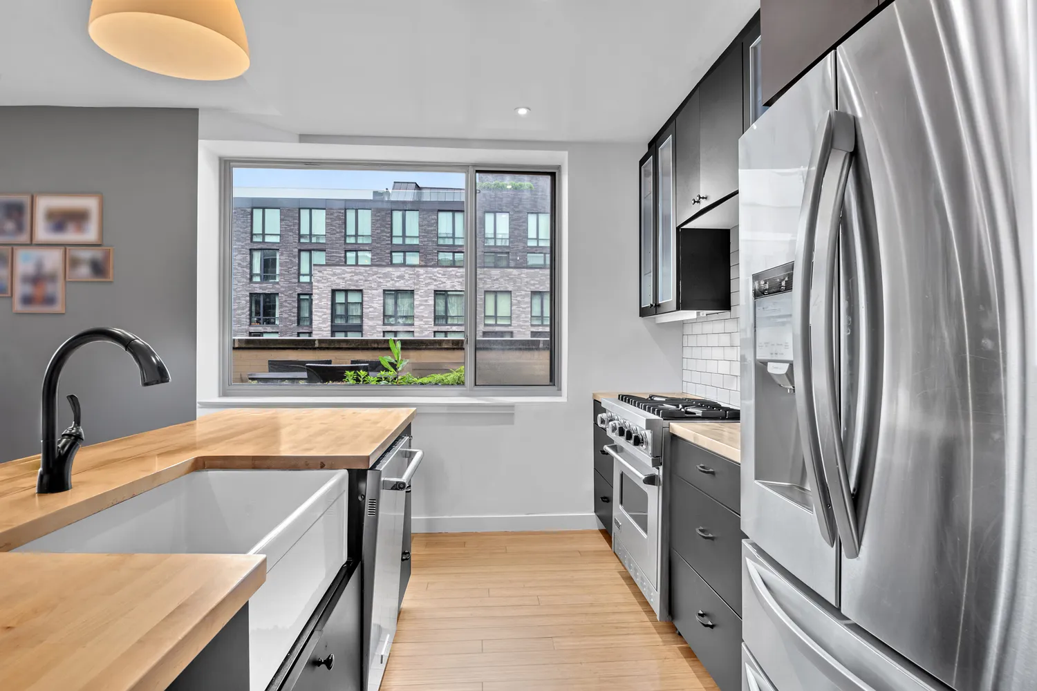 a kitchen with stainless steel appliances granite countertop a sink stove and refrigerator