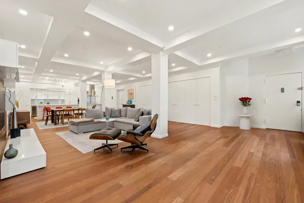 a living room with furniture and a wooden floor